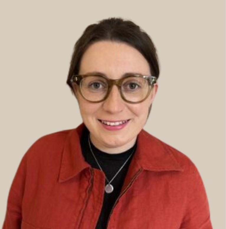 Headshot of Katie Lloyd wearing a red jacket